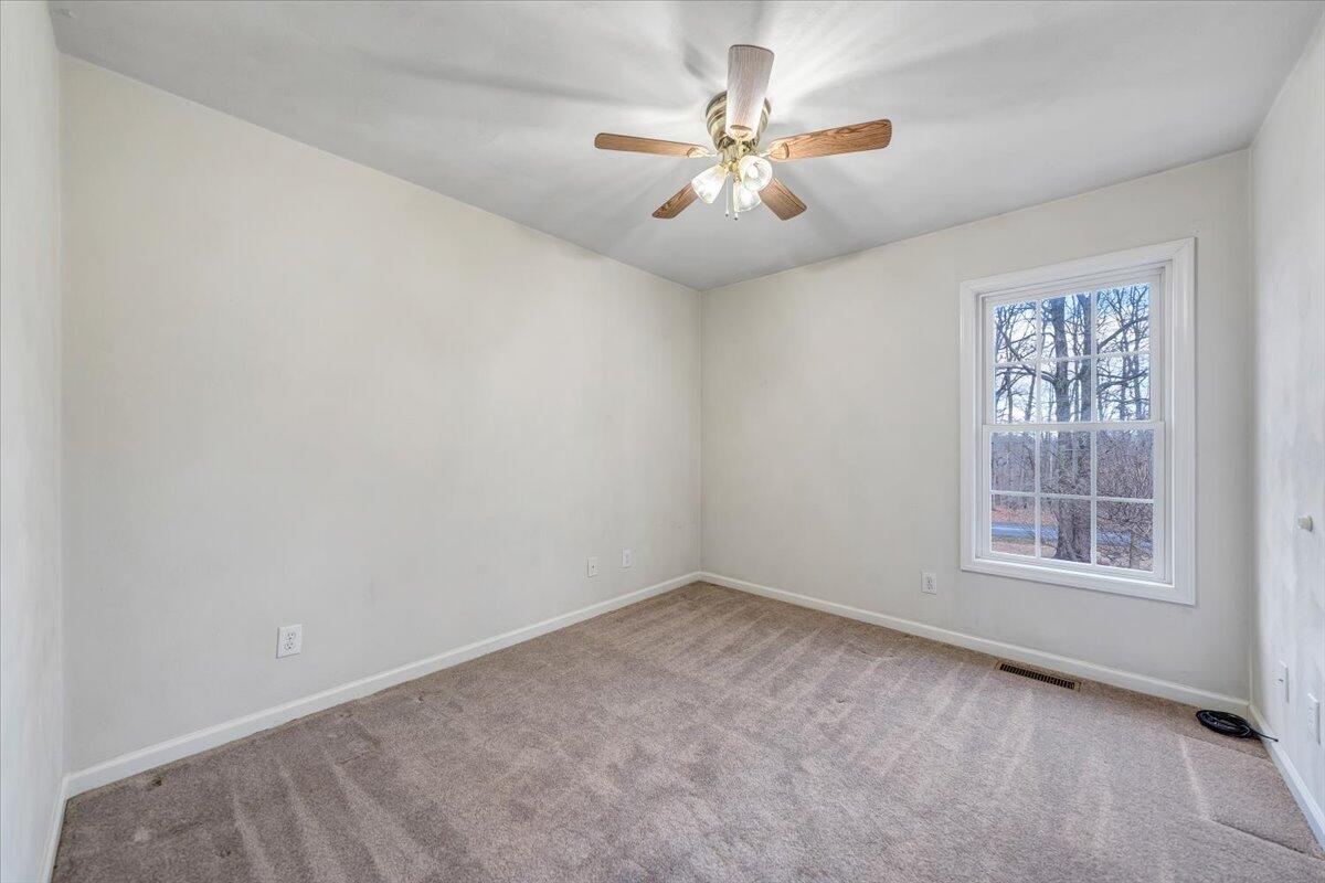 1093 Hales Ford Road Moneta, VA 24121 - Photo 18 of 45 an empty room with windows and chandelier fan