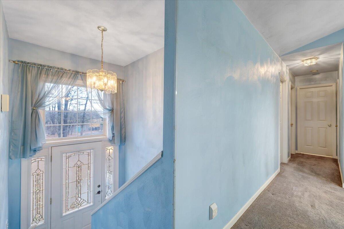 1093 Hales Ford Road Moneta, VA 24121 - Photo 3 of 45 a view of an empty room with wooden floor and a window