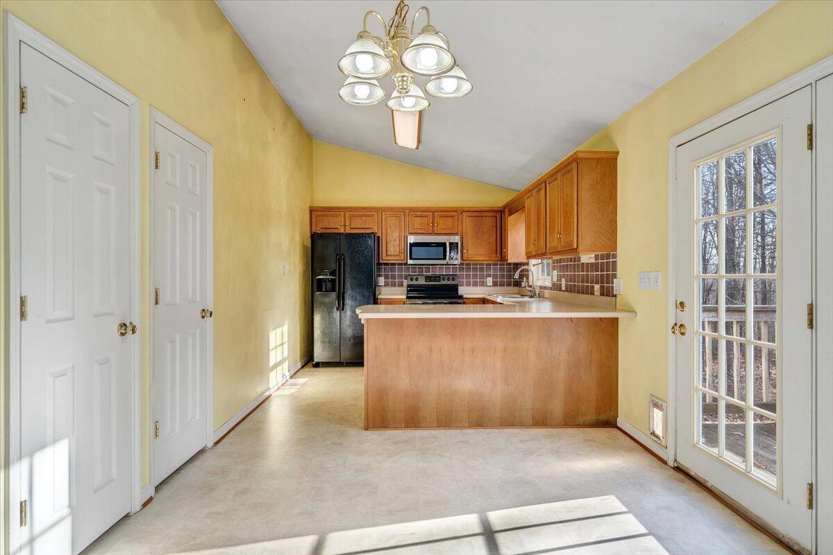 1093 Hales Ford Road Moneta, VA 24121 - Photo 8 of 45 a kitchen with stainless steel appliances granite countertop a stove and a refrigerator