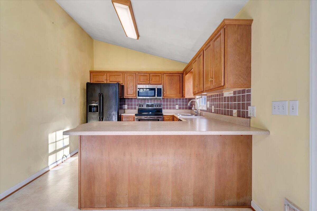 1093 Hales Ford Road Moneta, VA 24121 - Photo 9 of 45 a kitchen with stainless steel appliances a sink a stove a microwave a sink a refrigerator and cabinets