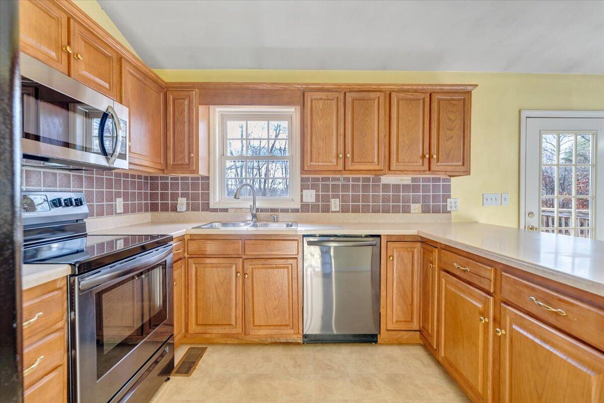 1093 Hales Ford Road Moneta, VA 24121 - Photo 10 of 45 a kitchen with stainless steel appliances granite countertop a sink stove and cabinets