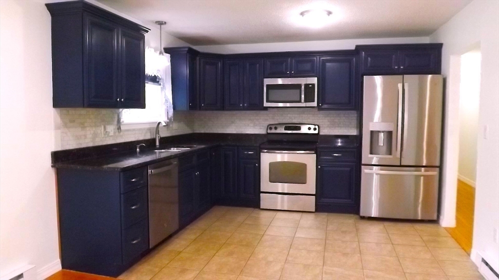 45 Cudworth Road Webster, MA 01570 - Photo 7 of 28 a kitchen with stainless steel appliances granite countertop a refrigerator stove and microwave