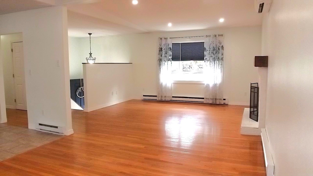45 Cudworth Road Webster, MA 01570 - Photo 8 of 28 an empty room with wooden floor