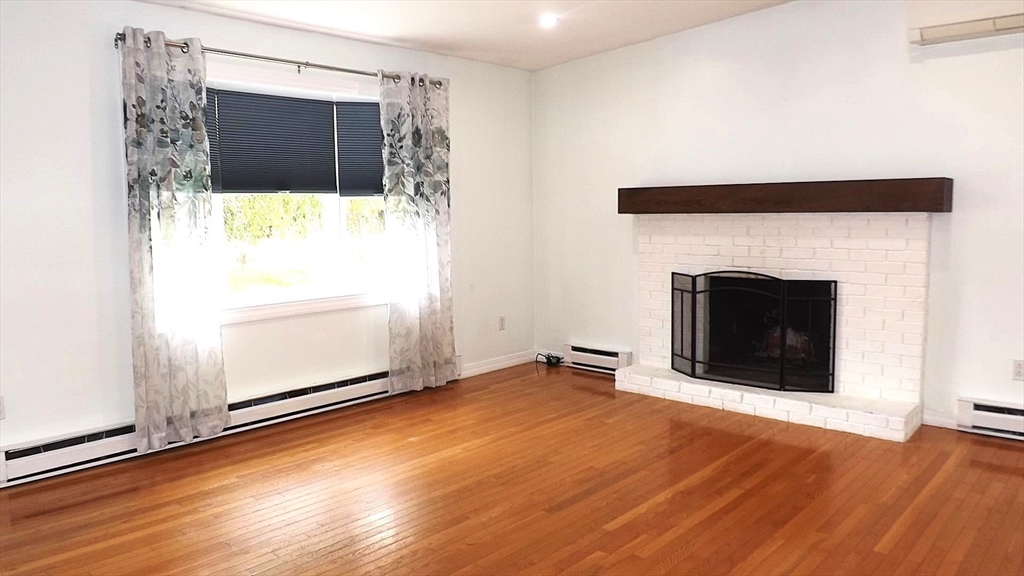 45 Cudworth Road Webster, MA 01570 - Photo 10 of 28 a view of a livingroom with wooden floor and a fireplace
