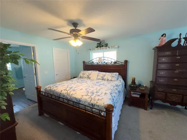 a bed sitting in a bedroom and dresser