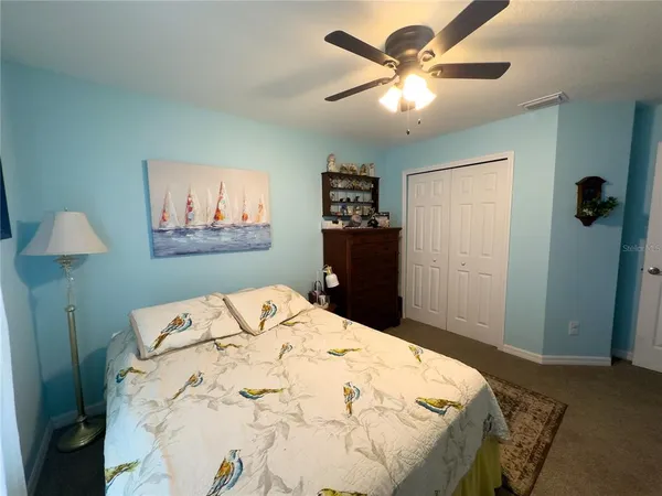 a bed sitting in a bedroom and a chandelier