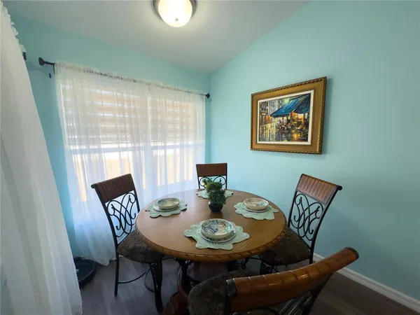a view of a dining room with furniture and wooden floor