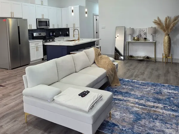 a living room with furniture and a counter space