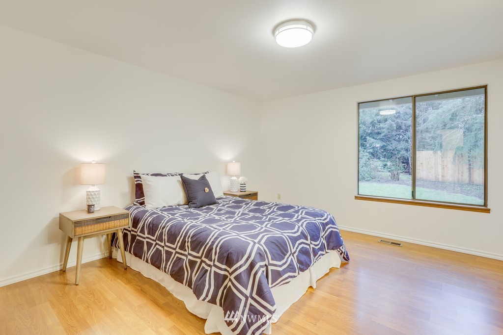 15909 Southeast 178th Street Renton, WA 98058 - Photo 21 of 30 a bedroom with a bed and a painting on the wall
