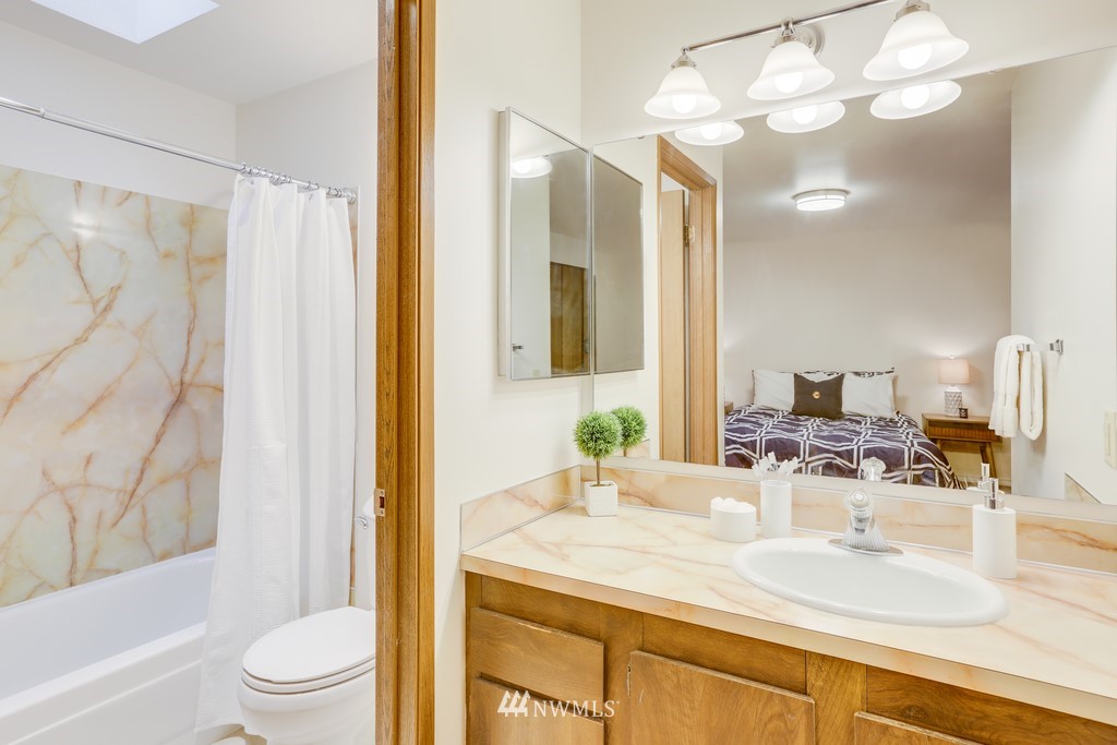 15909 Southeast 178th Street Renton, WA 98058 - Photo 23 of 30 a bathroom with a granite countertop sink toilet and shower
