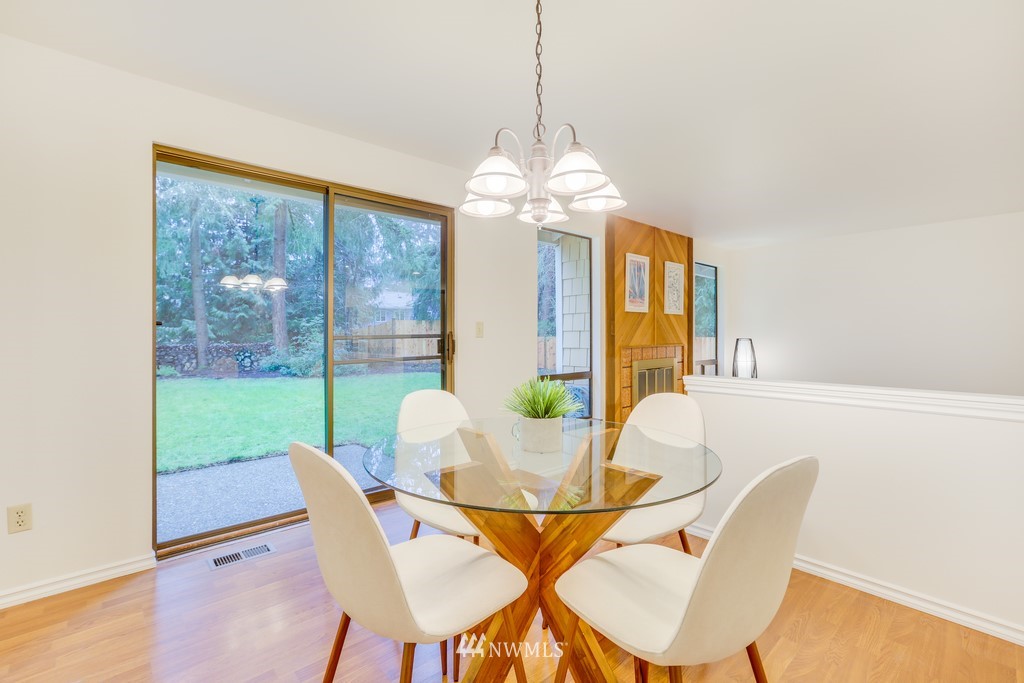 15909 Southeast 178th Street Renton, WA 98058 - Photo 10 of 30 a dining room with furniture a chandelier and wooden floor