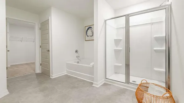 a spacious bathroom with a tub shower and a mirror