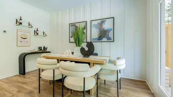 a view of a workspace with furniture and wooden floor