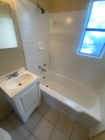 a bathroom with a sink a bathtub and a shower