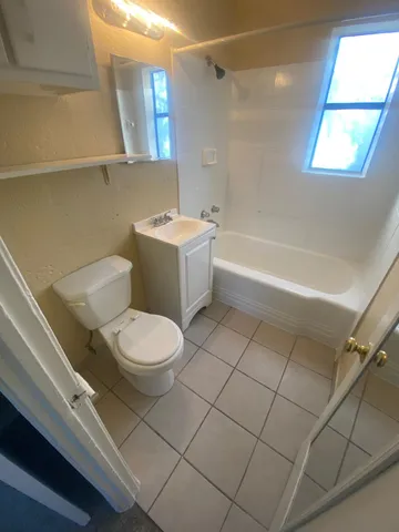 a bathroom with a toilet a sink and bathtub
