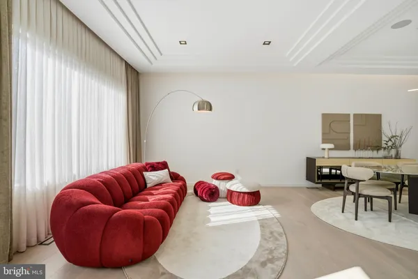 a living room with furniture a large window and a flat screen tv