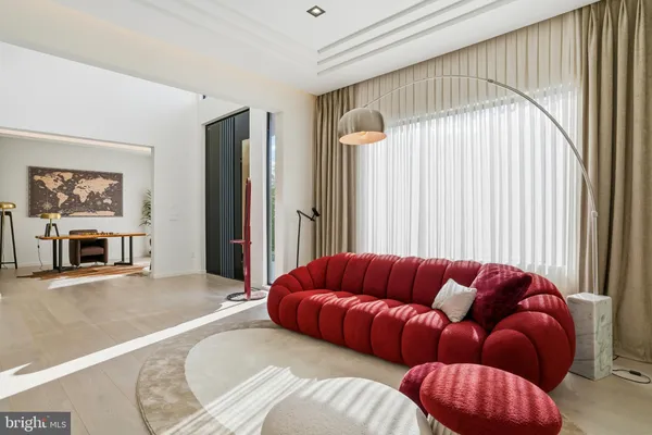 a living room with furniture a rug and a flat screen tv