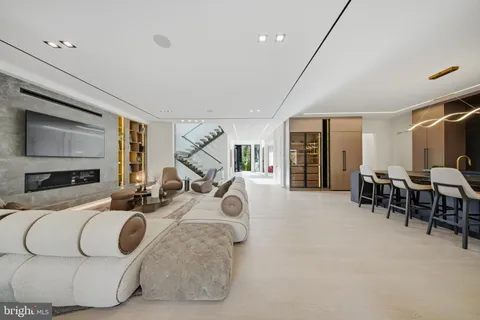 a bedroom with a large bed couch and a large window