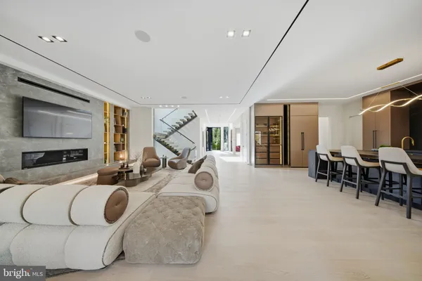 a bedroom with a large bed couch and a large window