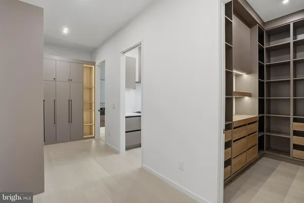 a view of walk in closet with empty racks