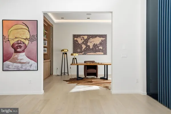a view of a livingroom and dining room with furniture wooden floor and a chandelier