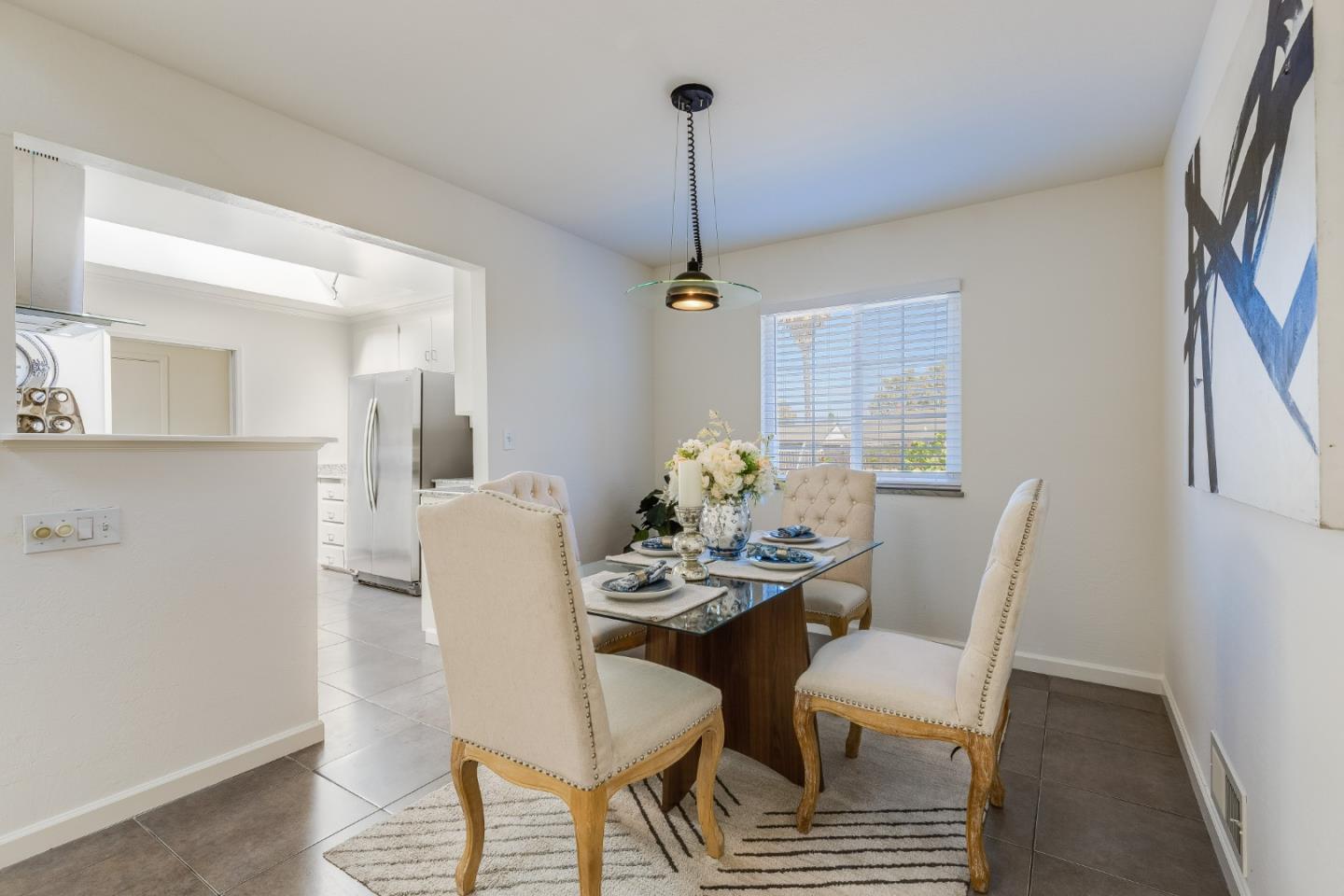 1253 Pomeroy Avenue Santa Clara, CA 95051 - Photo 4 of 17 a view of a dining room with furniture window and wooden floor