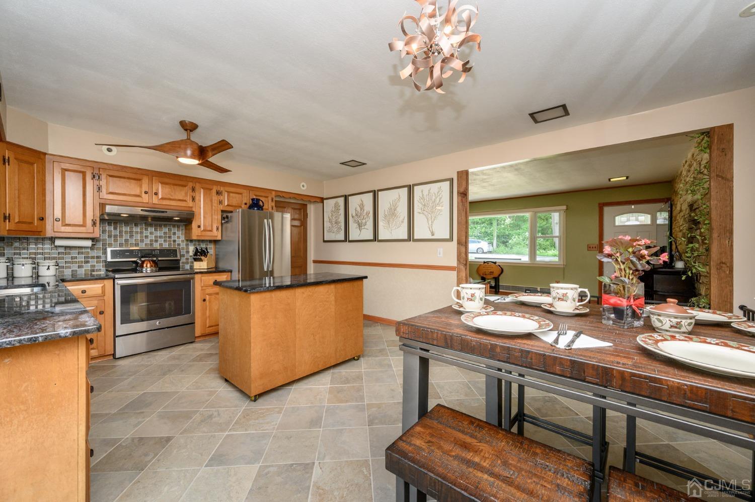 119 Mt Grove Road Califon, NJ 07830 - Photo 14 of 40 a kitchen with a table chairs stove and refrigerator