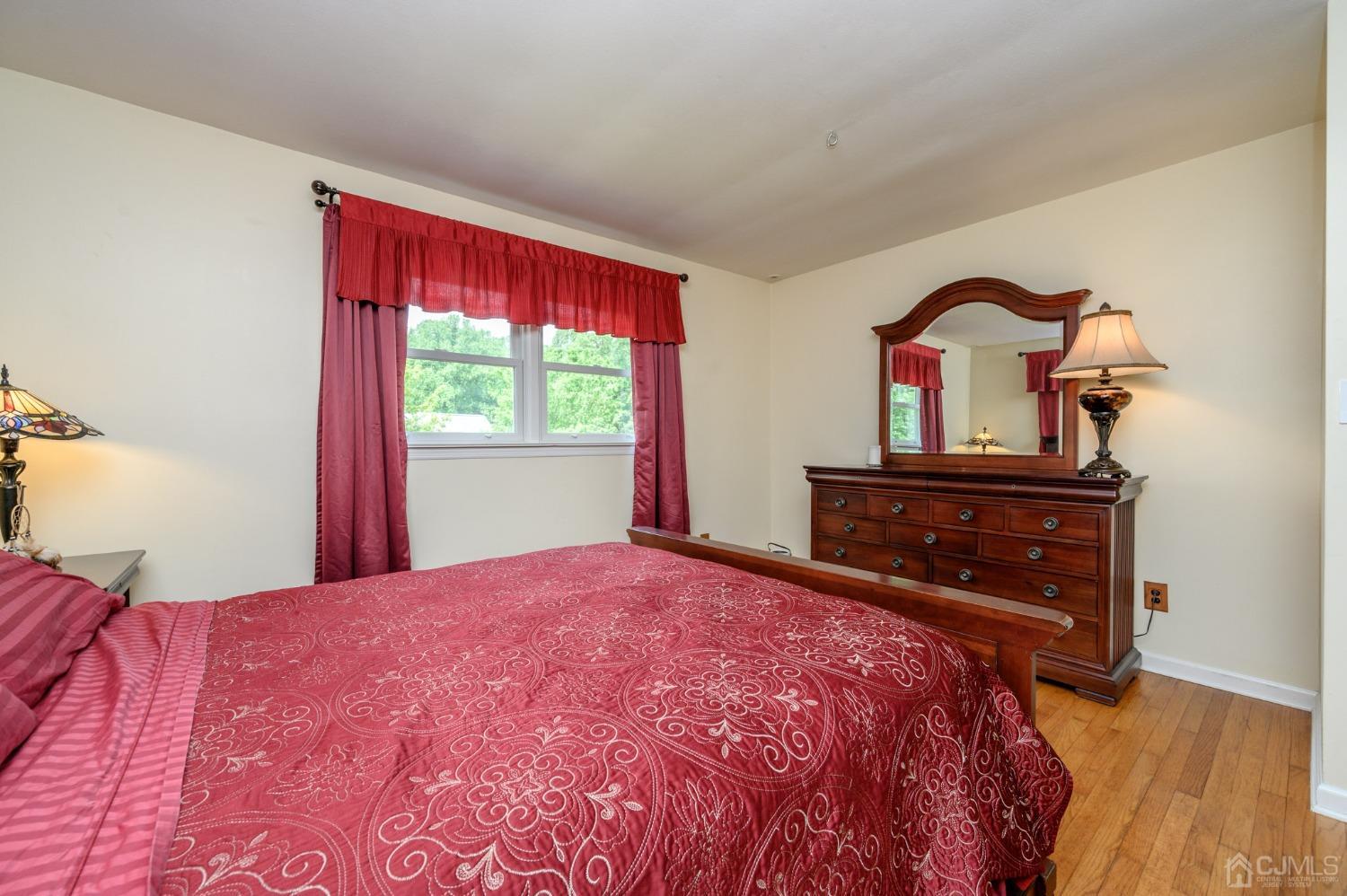119 Mt Grove Road Califon, NJ 07830 - Photo 18 of 40 a bedroom with a bed and a dresser with wooden floor