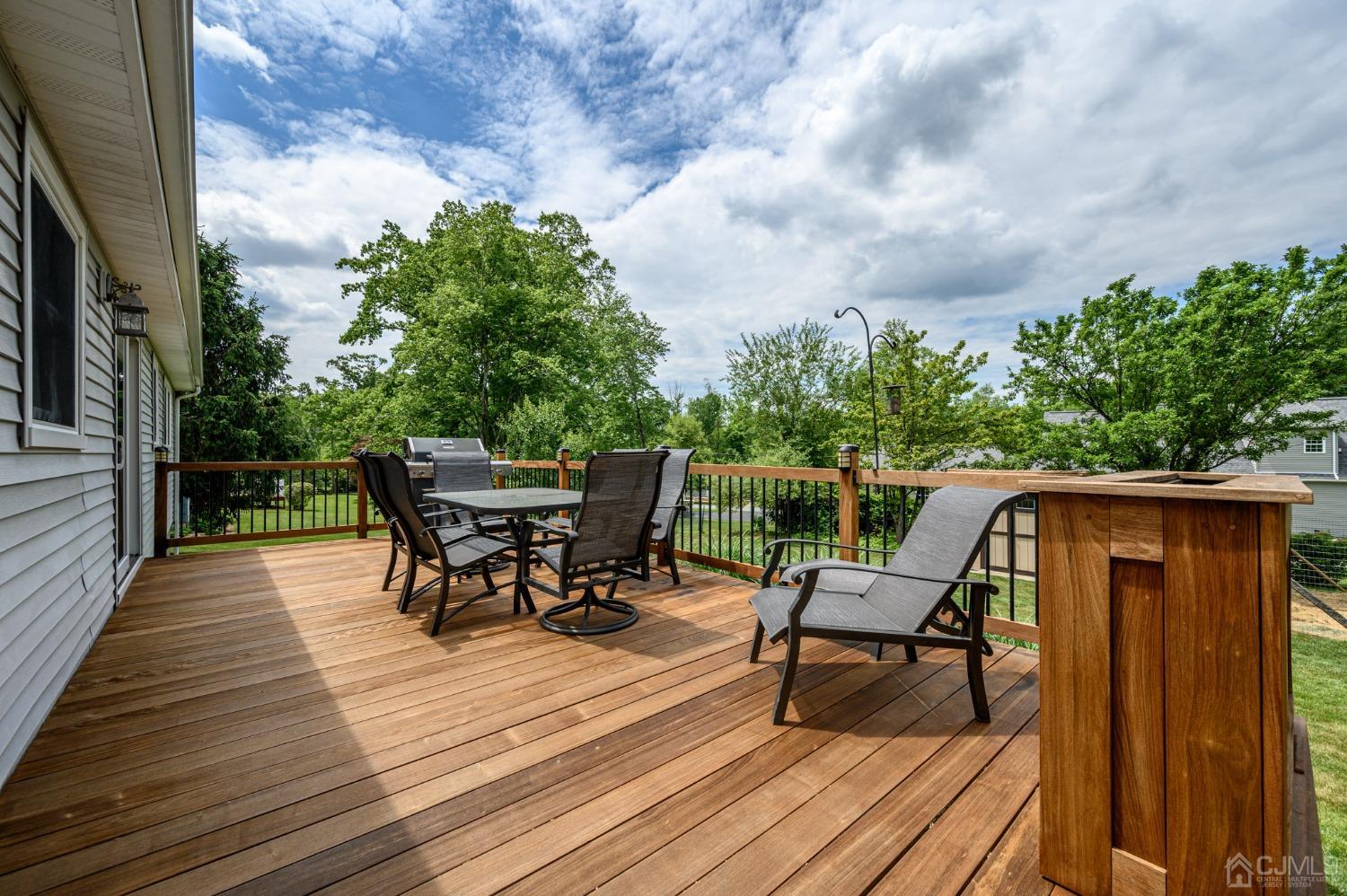 119 Mt Grove Road Califon, NJ 07830 - Photo 25 of 40 a view of a roof deck with table and chairs and wooden floor