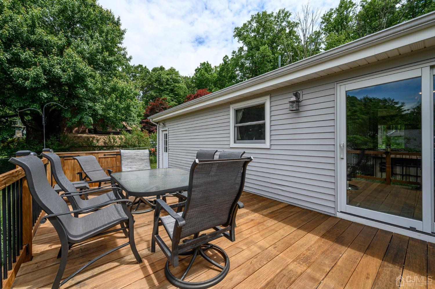 119 Mt Grove Road Califon, NJ 07830 - Photo 27 of 40 a view of a patio with table and chairs with wooden floor and fence