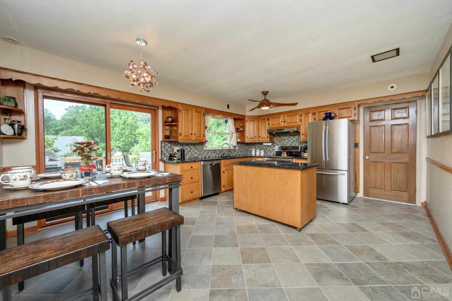 119 Mt Grove Road Califon, NJ 07830 - Photo 8 of 40 a kitchen with stainless steel appliances a stove a refrigerator and a dining table
