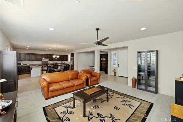 a living room with furniture and kitchen view