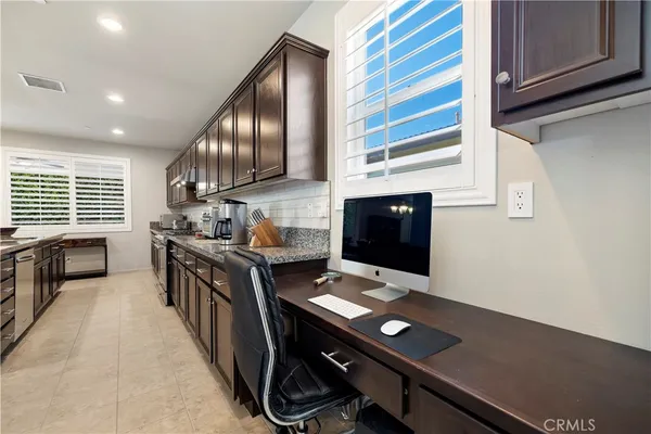 a kitchen with a stove window and cabinets