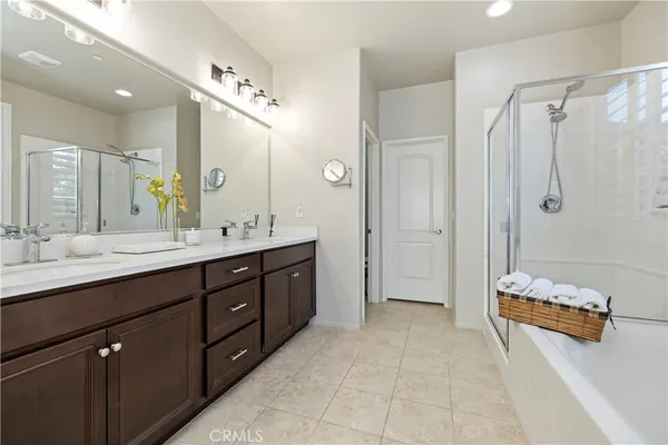 a spacious bathroom with a double vanity sink shower and a mirror