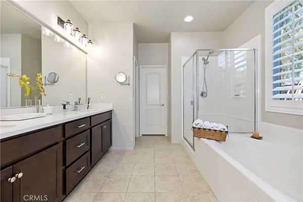 a spacious bathroom with a tub sink and mirror