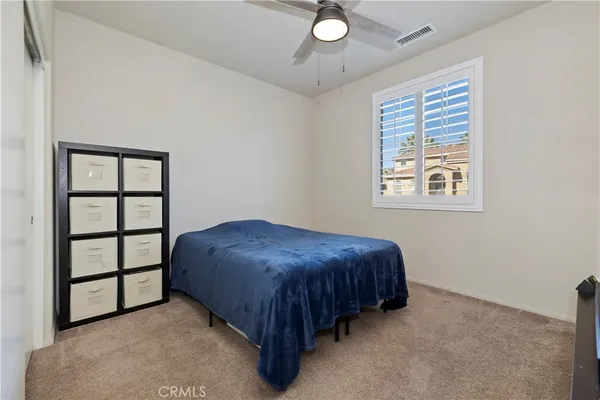 a spacious bedroom with a bed and a window