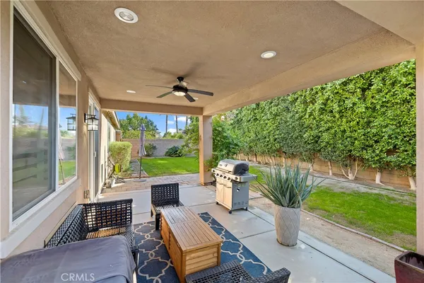 a view of an outdoor dining space with a table and chairs
