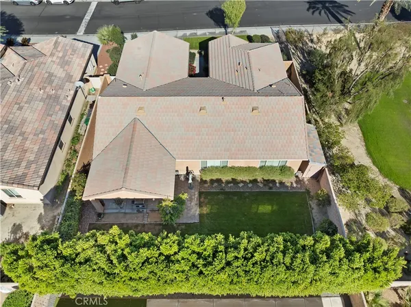 an aerial view of a house with a yard and lake view