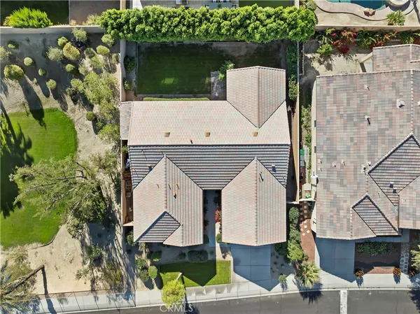 an aerial view of a house with a garden and plants