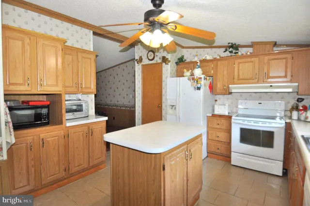 a kitchen with stainless steel appliances a stove cabinets and a dining table