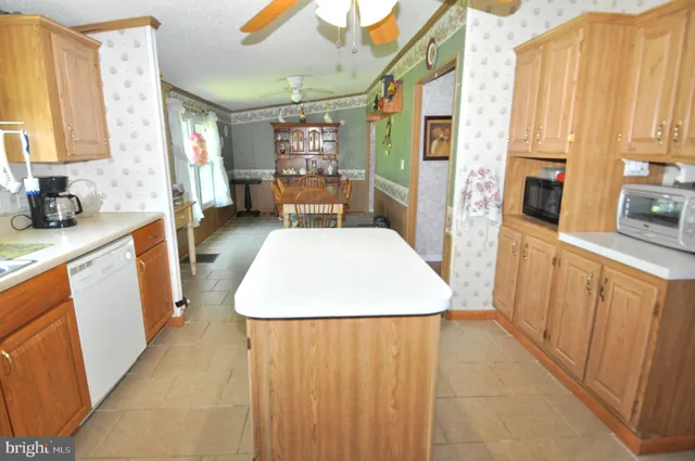 a view of a kitchen with fridge and wooden floor