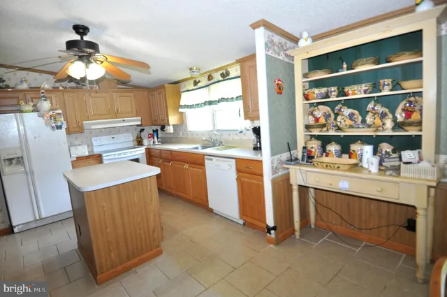 a kitchen with granite countertop cabinets and window