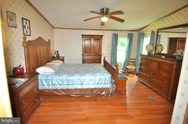 a living room with furniture dining table and wooden floor