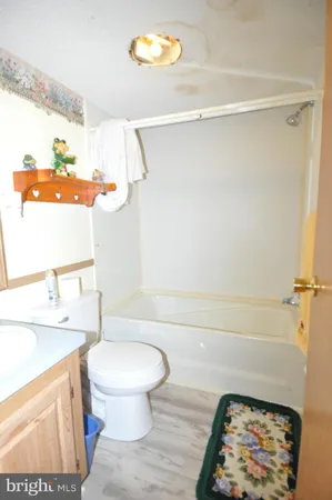 a bathroom with a sink a toilet and a shower curtain