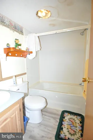 a bathroom with a sink a toilet and a shower curtain