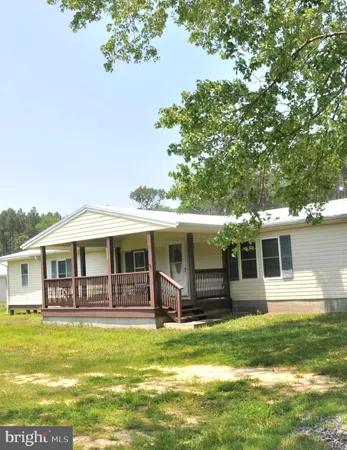 a front view of a house with a yard table and chairs