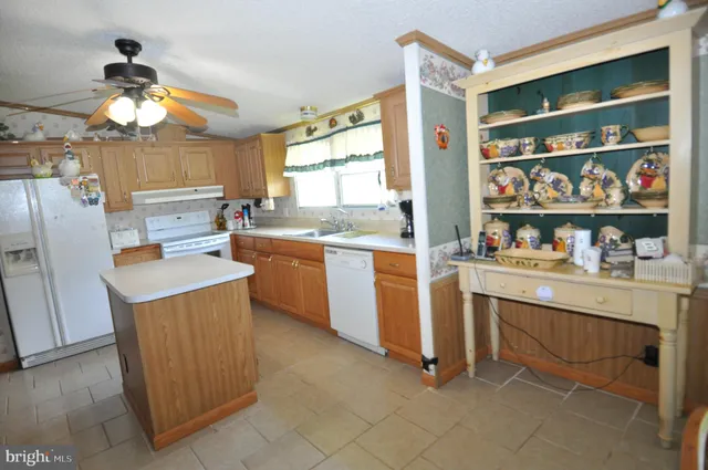 a kitchen with granite countertop cabinets and window