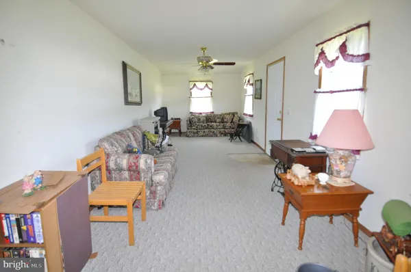 a living room with furniture and a lamp