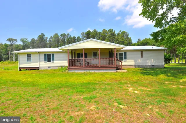 a view of a house with a backyard patio and swimming pool