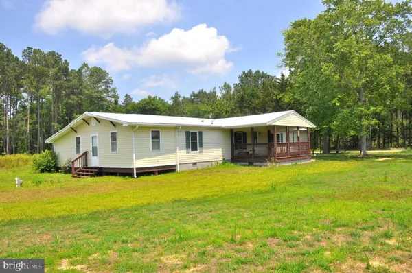 a front view of house with yard and swimming pool